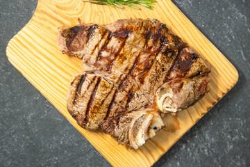 Juicy piece of grilled meat appetizingly displayed on a dark shale background