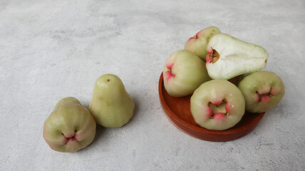 Deli green honey guava or jambu madu Deli Hijau which has a sweet and fresh taste. served on wooden plate. Water apple (water guava)