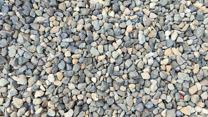 Ground stone grey background of many small stones. Selective focus