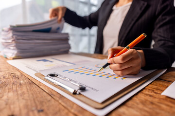 Document businesswoman hand working in finance department of paper files for searching and checking unfinished documents achieves folders papers at busy work desk office