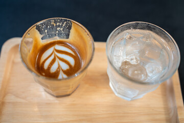 Hot coffee latte a cup of coffee cupucino on wood table background with warm morning sunlight concept lifestyle before working , Start day by coffee