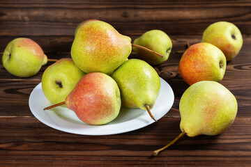Fresh pear fruit on plate with wooden table, Healthy fruit