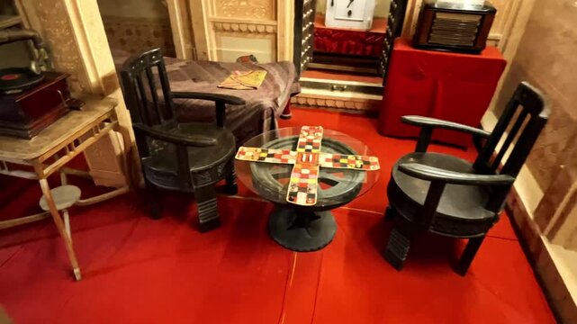 Pachisi, or Pasha a cross and circle board game, vintage board game on display at Patwon ki Haveli royal palace room interior with old furniture Jaisalmer Rajasthan India 4K