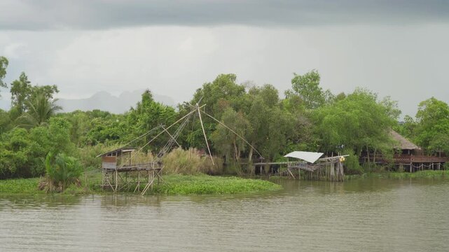 Aerial view of fishing trap net in canel with fisherman urban city village town houses, lake or river. Nature landscape fisheries and fishing tools at Pak Pha, Songkhla, Thailand. Aquaculture farming