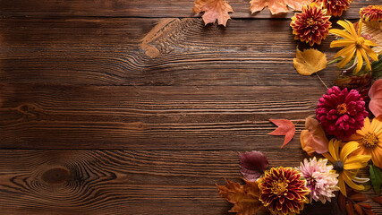 Fototapeta premium Fall flowers and leaves on old wooden table, flat lay, space for text