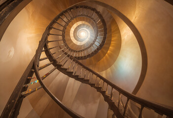 Obraz premium 3D Spiral Staircase Descending into Vibrant Vortex with Vintage Sepia and Neon Lighting