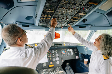 Mature commercial male pilot Beautiful middle aged woman airplane captain instructor has a meeting, discussion with aircrew team © Nuttapong punna