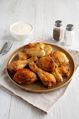 Homemade BBQ Chicken Drumsticks and Wings with Alabama White Sauce, side view.