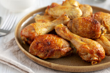 Homemade BBQ Chicken Drumsticks and Wings with Alabama White Sauce, side view.