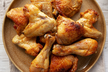 Homemade BBQ Chicken Drumsticks and Wings with Alabama White Sauce, top view.