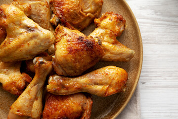 Homemade BBQ Chicken Drumsticks and Wings with Alabama White Sauce, top view. Copy space.
