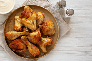 Homemade BBQ Chicken Drumsticks and Wings with Alabama White Sauce, top view. Copy space.