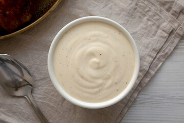 Homemade Alabama White Sauce for BBQ Chicken Drumsticks and Wings, top view.