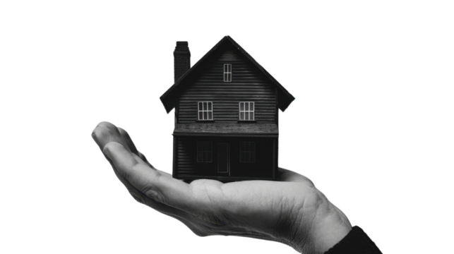 Hand holding a model house on transparent background