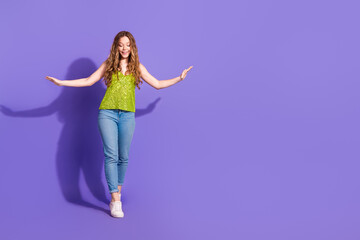 Full length photo of lovely teen lady keep balance walk tightrope dressed stylish green garment...