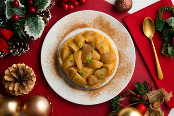 Delicious tarte tatin with apples from an overhead perspective. Food on a Christmas table.