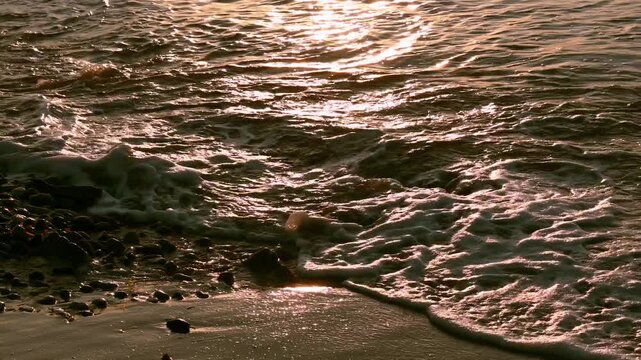 Sparkling water texture. Waves in the sea at sunrise.	
