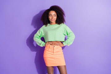 Photo of young tricky girl with chevelure hairstyle wearing green top posing looking copyspace...