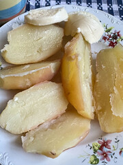 Close-up of freshly boiled potato served on a floral plate