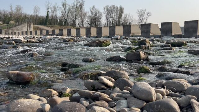 pebbles and stones in the river bed on sunny day enza. High quality 4k footage