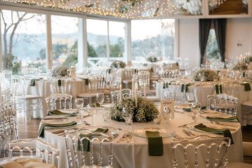 Elegant Wedding Reception Table Setting with Candles and Greenery at Evening Event
