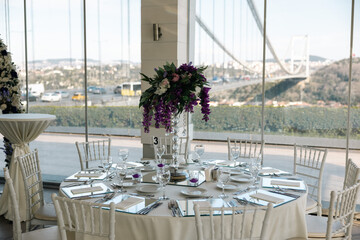 Elegant Wedding Reception Table Setting with Candles and Greenery at Evening Event