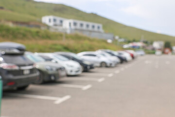 Blur outdoor car park in the official place and the hot sun. Cars parked in a row. blur and abstract background