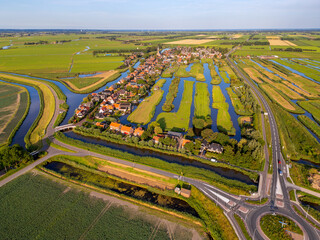 High angle Drone Point of View on the Village of Schermerhorn, Municipality of Alkmaar, North Holland, The Netherlands on summer evening in July
