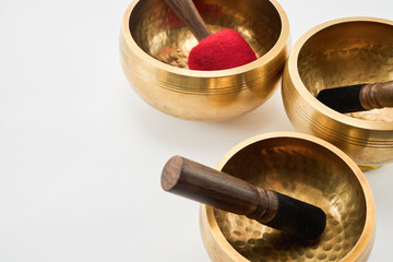 Harmony of Singing Bowls. Golden singing bowls with mallets creating a serene atmosphere.