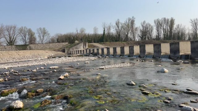 Enza river in Montecchio Emilia with barrier and dam. High quality 4k footage