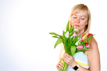 A Woman Holding a Beautiful Bouquet of Colorful Tulips Against a Bright White Background