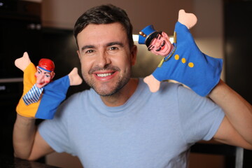 Guy holding some cute puppets 