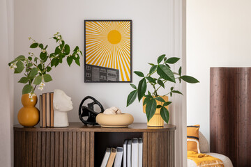 Stylish interior with a wooden cabinet plants, decorative objects, and books. A vibrant mock up art piece featuring a sunburst design adds a pop of color. Minimalist home decor. Template.