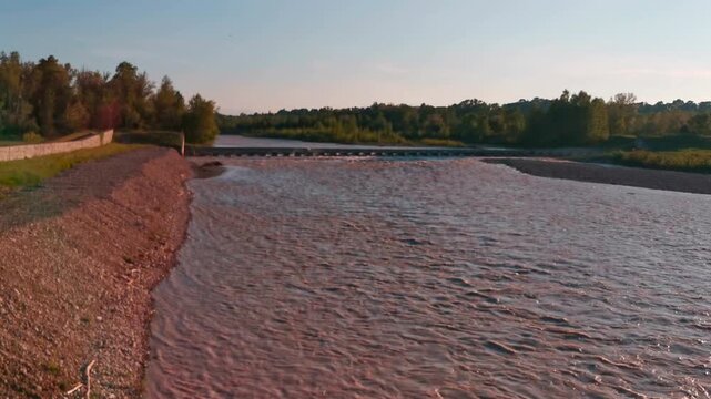 flood of the Enza river in Montecchio Emilia Italy at sunset. High quality 4k footage