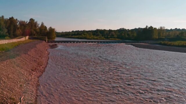 flood of the Enza river in Montecchio Emilia Italy at sunset. High quality 4k footage