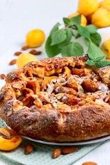 Homemade open pie (galette) with apricots.