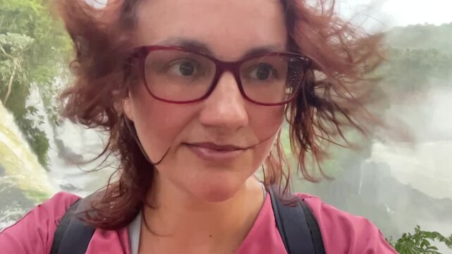 woman in glasses with red hair portrait making selfie in front of iguasu falls travel tourism places concept