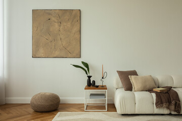 A minimalist living room with a cozy white sofa, wooden side table, and neutral decor. A large...