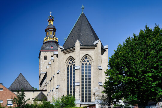 view from the east of the nave and tower of the romanesque basilica of st ursula against a blue sky in cologne