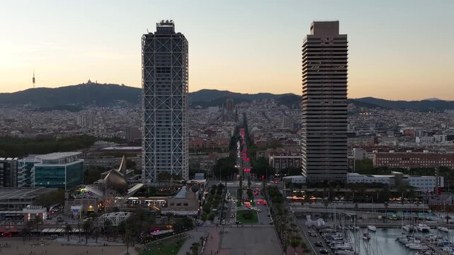 Aerial drone view of Barcelona. Night cityscape near Torre Mapfre and Hotel Arts towers. Sunset skyline. Marina street and Port Olimpic.