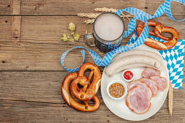 Traditional Oktoberfest set. Pretzels, beer, weisswurst, eisbein with mustard. German festival food