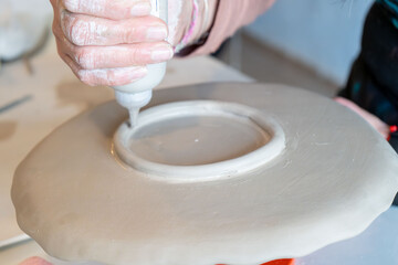 shape clay with hands	