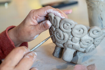 shape clay with hands	