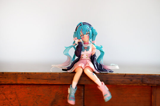 Hatsune Miku figure with white background with copy space. Virtual singer with vocaloid. Japanese manga and anime style doll.	
