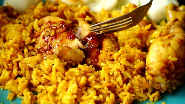 Man is eating chicken Biryani in plate, in door Chiangmai Thailand.