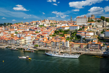 Obraz premium Aerial view of Porto city and Douro river with moored sailling ship from Dom Luis I bridge. Porto, Portugal