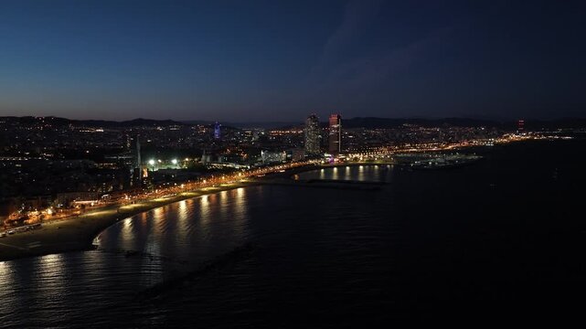 Aerial drone panorama of Villa Olimpica del Poblenou, in the city of Barcelona. Twin skyscrapers of Hotel Arts and Torre Mapfre next to Port Olimpic.