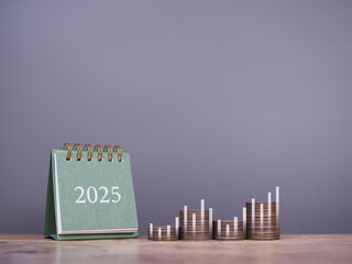 2025 desk calendar, Stack of coins with virtual increasing graph. The concept of business growth,...