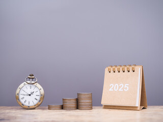 Vintage watch, 2025 desk calendar and stack of coins. The concept of saving money and manage time to success business in year 2025.