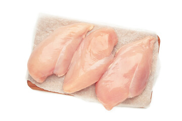 Raw chicken fillet on a cutting board isolated on white background. Top view